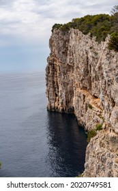 A vertical view of the rocky cliffs and the sea of Dlugi Otok, Croatia - Shutterstock ID 2020749581