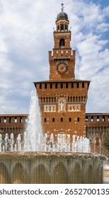Vertical view of Sforza Castle’s clock tower in Milan, showcasing medieval architecture, red bricks, and historic design. Perfect for travel, tourism, and cultural heritage visuals.