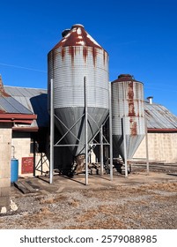 Vertical view of Silo Feed Container On Southern Rural Horse Farm On A Sunny Blue Day During Golden Hour in Tennessee 