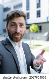 vertical view smartphone camera Caucasian bearded businessman speaks on phone using a front camera on a video call. employee business man talking on webcam. Conversation of an office worker in suit
