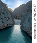 A vertical view of the Torrent de Pareis Gorge and beach on the rugged mountain coast of northern Mallorca