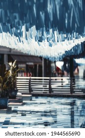 A Vertical View Of An Urban Public Area With Bluish And White Tapes Hanging On The Top A Blue-tiled Pool In The Bottom And Bridge In A Defocused Background A Shallow Depth Of Field, Selective Focus