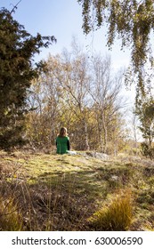 Vertical View Of A Woman Contemplating And Experiencing Swedish Nature, Getting Away From Daily Stress Of Life, And Taking Time Off To Relax And Enjoy Me Time In Sunny Weather To Uplift Her Spirit.