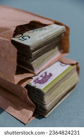 Vertical Wad of Argentine bills in envelope - Shutterstock ID 2364824231