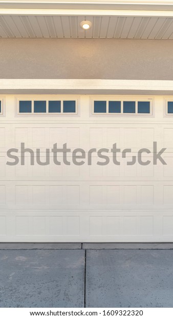 Vertical White\
automatic garage door for two\
cars