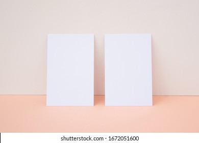 Vertical White Business Card Mockup On Light Peach Color Background