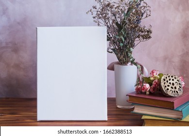 Vertical white empty canvas board in stylish cozy interior. Spring home decor and mockup poster frame. 