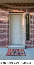 Vertical White Entrance Door With Welcome Mat Day Light