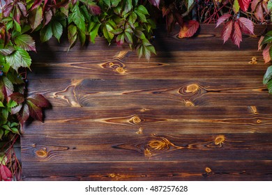 Vertical wooden background made of planks framed by autumn leaves   - Powered by Shutterstock