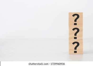 vertical wooden block in question mark mean what on cement table black background wood cube business teamwork concept