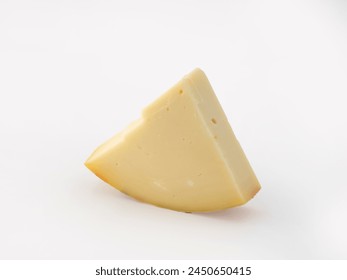 vertically positioned wedge slice of typical Italian spicy provolone cheese on isolated white background