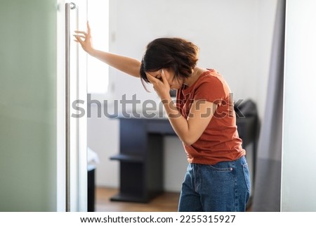 Vertigo Concept. Young Middle Eastern Woman Feeling Unwell At Home, Ill Arab Female Suffering Head Spinning, Depressed Millennial Lady Leaning At Doorjamb, Having Problems With Health, Free Space