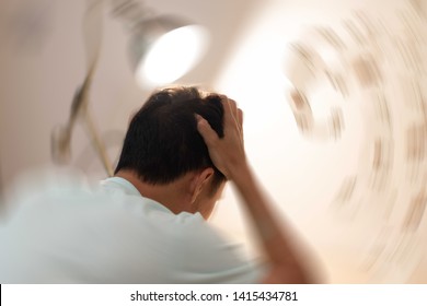 Vertigo illness concept. Man hands on his head felling headache dizzy sense of spinning dizziness,a problem with the inner ear, brain, or sensory nerve pathway.