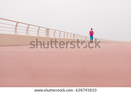 Similar – Senior sportswoman with headphones running