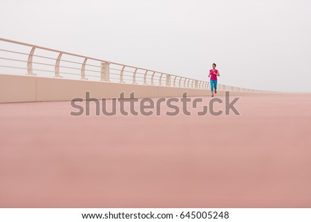 Similar – Senior sportswoman with headphones running