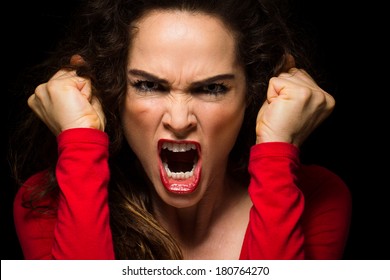 A Very Angry Aggressive Woman Is Clenching Her Fists In Rage