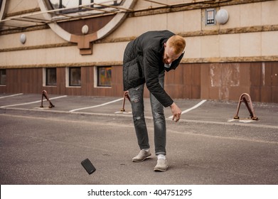 Very Angry Man Is Throwing Away His Mobile Phone