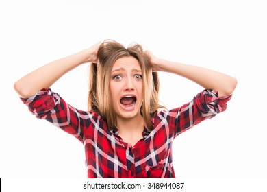 A very angry woman pulling her hair isolated on white background