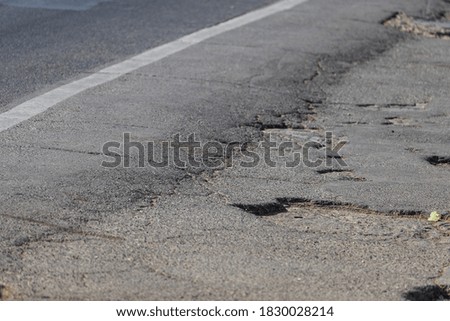 Similar – Potholes in asphalt / road damage