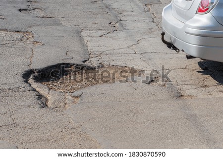 Similar – Potholes in asphalt / road damage