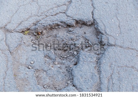 Similar – Potholes in asphalt / road damage