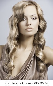 Very Beautiful And Attractive Young Blond Lady In Elegant Silk Dress And With Old Fashion Hair Style