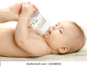 The Very  Beautiful  Little Baby Drink Of  Bottle, Lie On White Background, Isolated