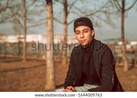 Very beautiful moroccan boy with beautiful style. Moroccan young boy with street style in the park. 