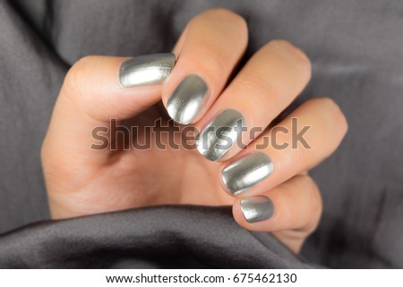 Very beautiful silver metallic nails closeup.