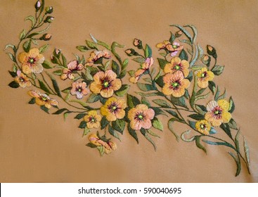 Very Beautiful Ukrainian Hand Embroidery. Embroidered Yellow And Golden Flowers On A Mustard-colored Fabric. Flower Composition. Design Of The National Fashionable, Stylish Author's Modern Embroidery.