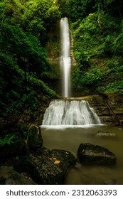 Very beautiful waterfall in the tropical rainforest of the Mentawai islands, west Sumatra, Indonesia. surrounded by tall lush trees, and clear water, perfect for adventure. Slow-speed photo.  - Shutterstock ID 2312063393