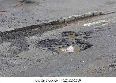 Very Big Pot Hole Filled With Water At Street