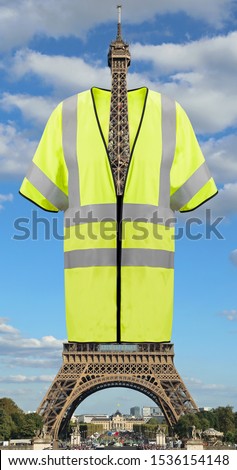 Very Big Yellow jacket symbol of Yellow vests movement on Eiffel Tower in Paris France. This is a photomontage. Not Really