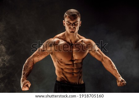 Very brawny guy bodybuilder posing. Beautiful sporty guy male power. Fitness muscled man. Roar.