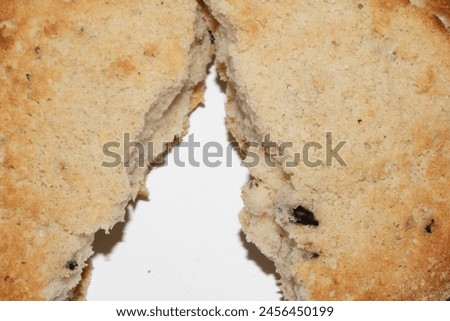 A Very Burnt Bread Roll Torn or Cut in Half Toast Close Up Texture