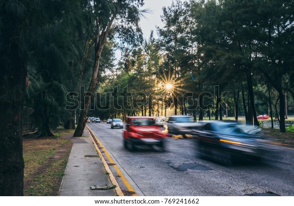 Very\
busy road with cars in motion at the golden\
hour