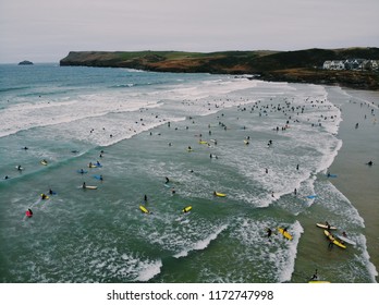 A Very Busy Surf Lineup. A Stormy Summers Day Ay Polzeath, Cornwall With Hundreds Of Surfers Trying To Head Out Against The Stormy Waves. 