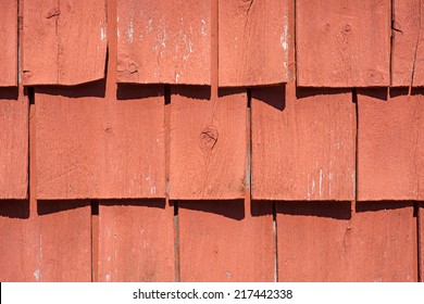 A Very Close View Of Old Painted Wood Shingles That Are Curling With Age And Exposure To The Sunlight.