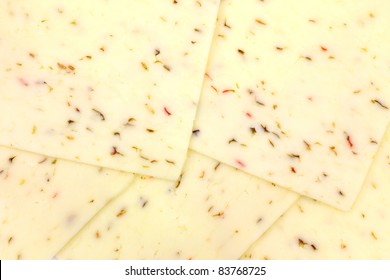 A Very Close View Of Several Pepper Jack Cheese Slices.