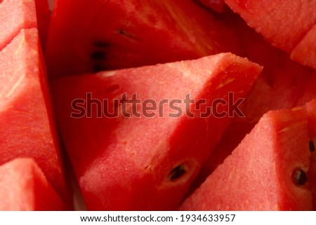 Very closed up shot, Sliced pieces of red vibrant color freshly cut juicy watermelon for background usage close up shot, under summer time, happy, hot climate, nutrition food drink beverage concept