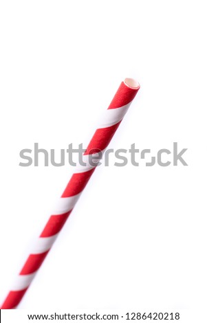 Very closeup of drinking straw for party.  Red spiral. Top view of colorful disposable eco-friendly straw for summer cocktails. Paper coctail colorful straw isolated on white  background, isolated.