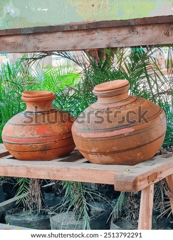 very cute two earthen pots it is made in pakistan its name is pakistan ghada it is used a lot by people in pakistan it is very cute picture They are used for storing water and for cooling.🥰