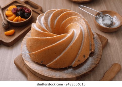 A very delicious and tempting cake served with powdered sugar and fruit - Powered by Shutterstock