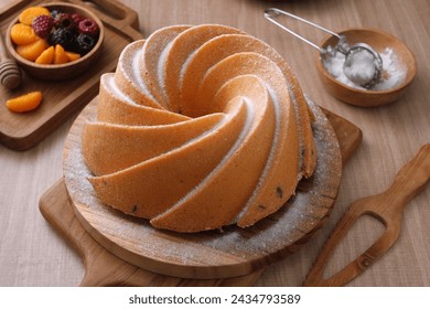 A very delicious and tempting cake served with powdered sugar and fruit - Powered by Shutterstock