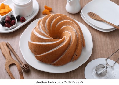 A very delicious and tempting cake served with powdered sugar and fruit - Powered by Shutterstock