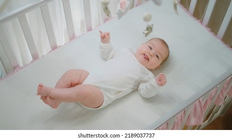 Very Excited Baby Girl Enjoy The Time In Her Baby Cot Alone She Moving With Her Cute Legs And Looking At Cot Toys