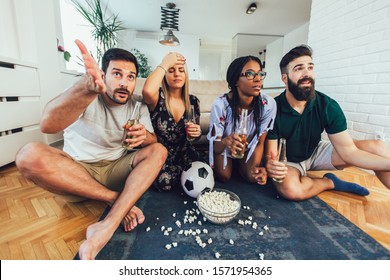 Very Excited Friends Having Fun By Watching Football Match, Drinking Beer And Eating Popcorn At Home 