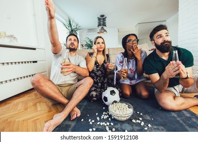 Very Excited Friends Having Fun By Watching Football Match, Drinking Beer And Eating Popcorn At Home 