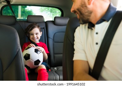 Very Excited To Play Soccer. Portrait Of An Adorable Young Boy Sitting In The Car On His Way To Football Practice With His Dad 