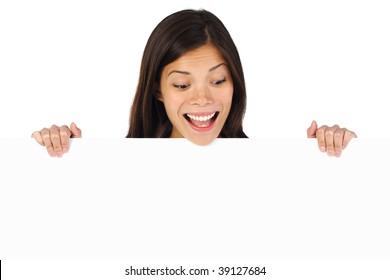 Very excited woman holding billboard / blank sign looking down. Isolated on white background - Powered by Shutterstock